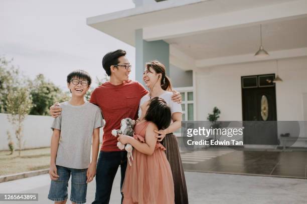 an asian chinese family moving into new house having portrait in front of their house - lawn mover stock pictures, royalty-free photos & images