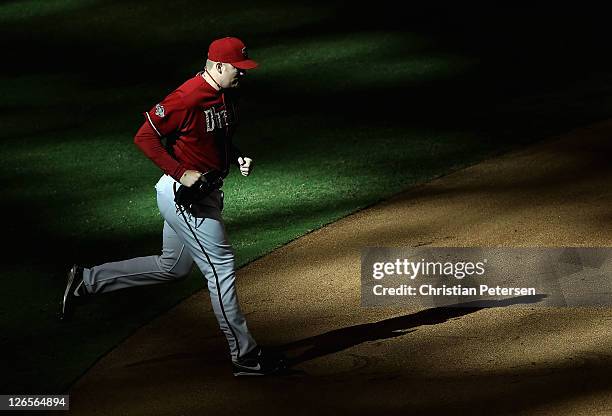 Relief pitcher J.J. Putz of the Arizona Diamondbacks runs onto the field to pitch during the ninth inning of the Major League Baseball game against...