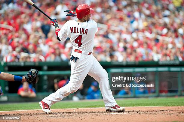 Catcher Yadier Molina of the St. Louis Cardinals hits a solo homerun in the 7th inning against Randy Wells of the Chicago Cubs on September 25, 2011...