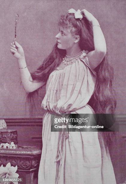 Girl with very long hair looks in a hand mirror, original print from the year 1899, das Mädchen mit dem sehr langen Haar schaut in einem Handspiegel,...