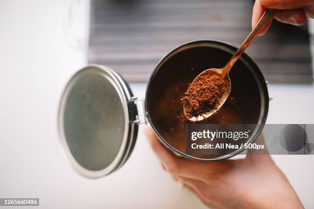 cropped hands of woman scooping ground coffee from reusable container, lleida, spain - coffee powder bildbanksfoton och bilder