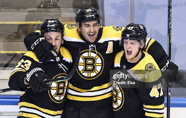 Patrice Bergeron of the Boston Bruins scores at 1:13 of the second overtime against the Carolina Hurricanes during the second overtime period and is...