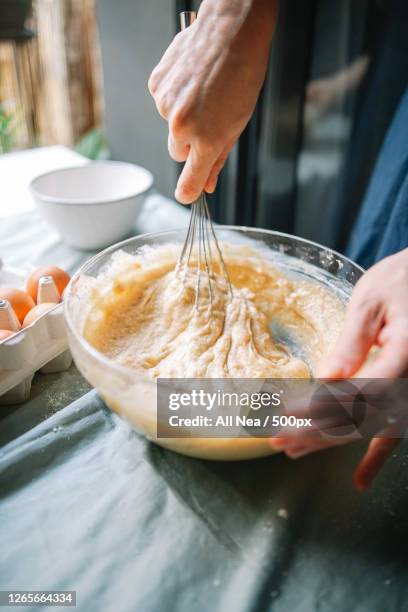 woman preparing mixing ingredients in bowl, lleida, spain - making a cake stock pictures, royalty-free photos & images