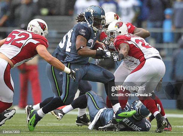 Running back Marshawn Lynch of the Seattle Seahawks rushes against Stewart Bradley and Patrick Peterson of the Arizona Cardinals at CenturyLink Field...