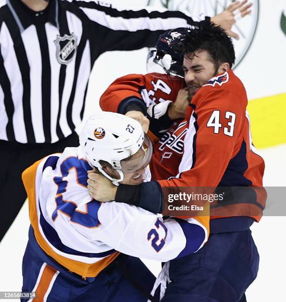 Tom Wilson of the Washington Capitals and Anders Lee of the New York Islanders fight during the first period in Game One of the Eastern Conference...