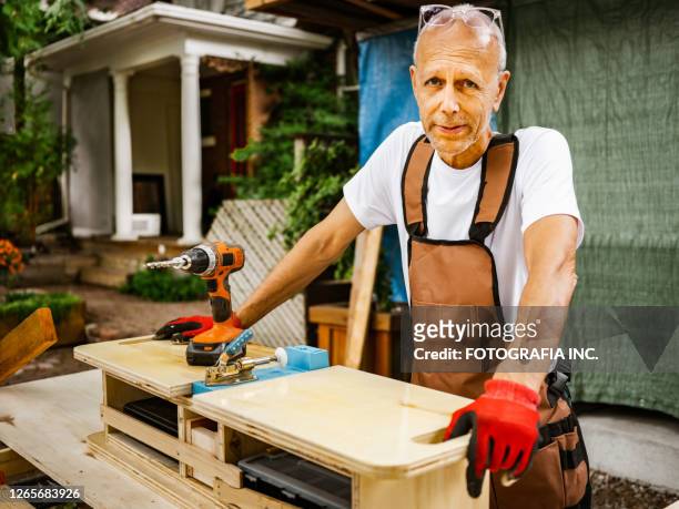 senior hobby carpenter-man outdoors - baby boomer working stock pictures, royalty-free photos & images