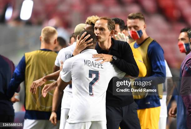 Thomas Tuchel, Manager of Paris Saint-Germain embraces Kylian Mbappe of Paris Saint-Germain after the UEFA Champions League Quarter Final match...