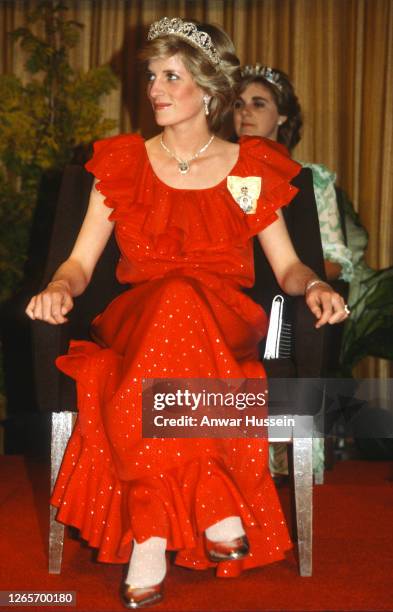 Diana, Princess of Wales, wearing a red dress designed by Bruce Oldfield, the Spencer Tiara and the Royal Family Order of the Queen and the Prince of...