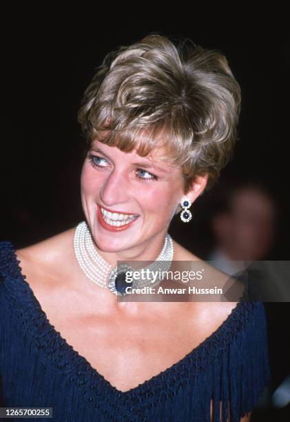 Diana, Princess of Wales, wearing a blue fringed cocktail dress and a sapphire and pearl choker, during a visit to the National Arts Centre on...
