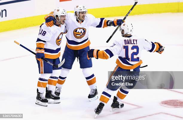 Anthony Beauvillier of the New York Islanders celebrates his goal at 11:55 of the third period against the Washington Capitals and is joined by...