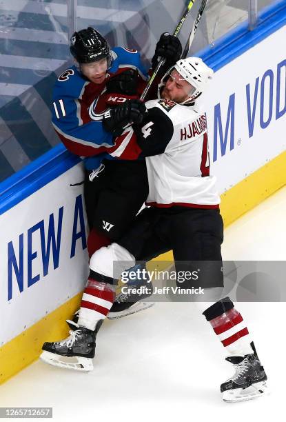 Niklas Hjalmarsson of the Arizona Coyotes checks Matt Calvert of the Colorado Avalanche during the second period in Game One of the Western...