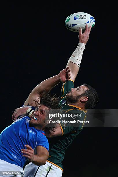 Danie Rossouw of South Africa wins the line out ball ahead of Jacques Nieuwenhuis of Namibia during the IRB 2011 Rugby World Cup Pool B match between...