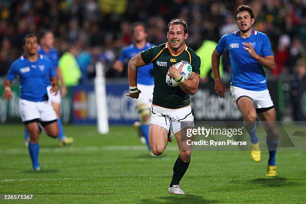 Francois Hougaard of South Africa runs with the ball during the IRB 2011 Rugby World Cup Pool B match between South Africa and Namibia at North...