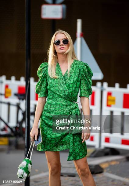 Guest is seen wearing green dress outside Henrik Vibskov during Copenhagen Fashion Week Spring/Summer 2021 on August 12, 2020 in Copenhagen, Denmark.