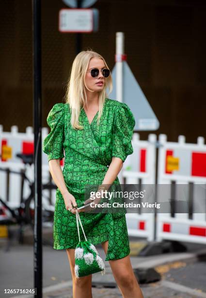 Guest is seen wearing green dress outside Henrik Vibskov during Copenhagen Fashion Week Spring/Summer 2021 on August 12, 2020 in Copenhagen, Denmark.