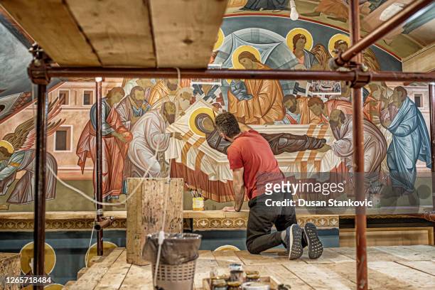 artist on the scaffolding inside the church paints the walls with frescoes of angels and saints - restoring art stock pictures, royalty-free photos & images
