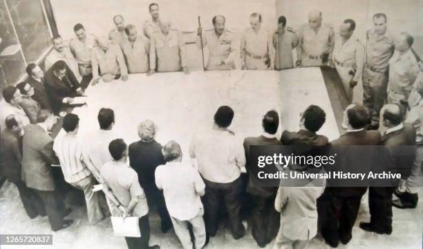 Photograph of President Sadat briefing military correspondents and newspaper editors before the beginning of the October War.