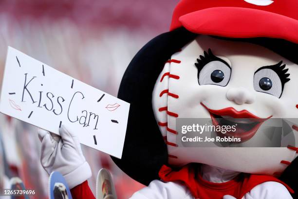 Cincinnati Reds mascot Rosie Red flashes a Kiss Cam sign while roaming ths stands in the fourth inning of the game against the Kansas City Royals at...