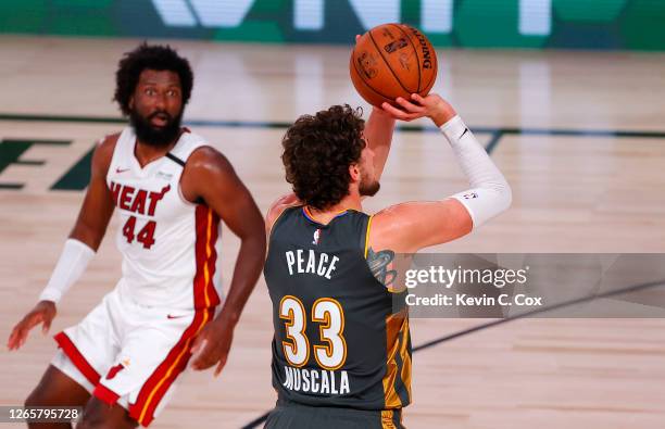 Mike Muscala of the Oklahoma City Thunder shots the game winning three point basket against Solomon Hill of the Miami Heat during the fourth quarter...