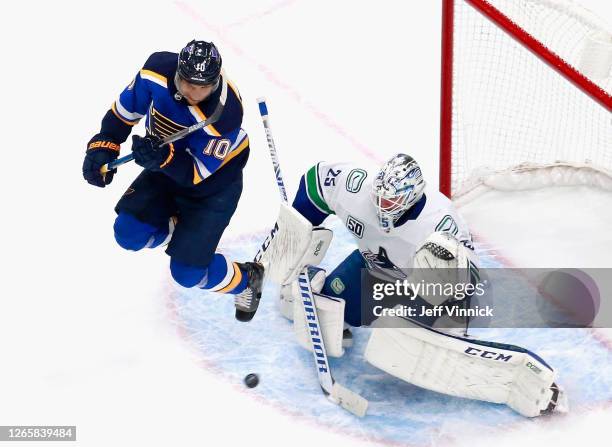 Brayden Schenn of the St. Louis Blues jumps to screen Jacob Markstrom of the Vancouver Canucks during the second period in Game One of the Western...