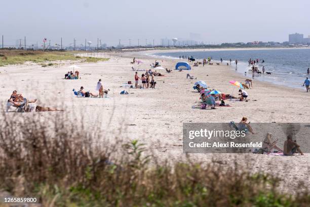 People are seen observing social distance at the beach as the state continues Stage 2 of re-opening following restrictions imposed to slow the spread...