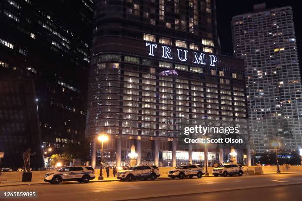 Chicago Police park across the Chicago River from Trump Tower as the city continues increased security measures which include raising the bridges...