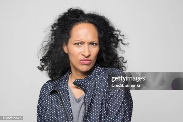 portrait of frowning woman - frowning stock pictures, royalty-free photos & images