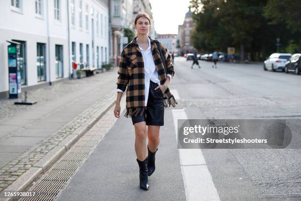 Influencer Jacqueline Zelwis, wearing a yellow black checked jacket with fringes by Sandro, a white blouse by Gestuz, black cowboy boots by Fendi, a...