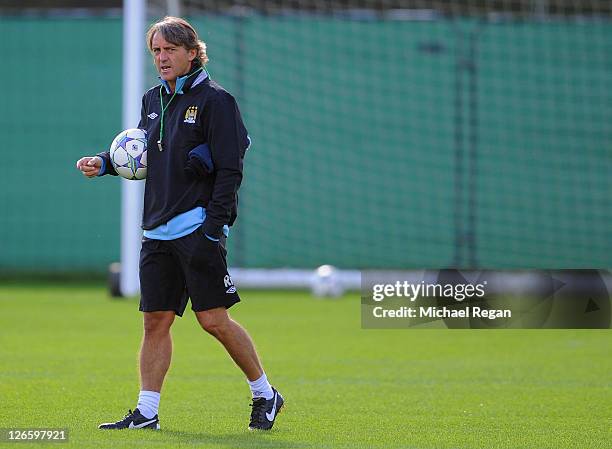 Manager Roberto Mancini supervises a Manchester City training session ahead of their UEFA Champions League Group A match against Bayern Munich on...