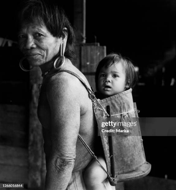 British Asia. Borneo. A Dayak With His Son On His Back. 1955.