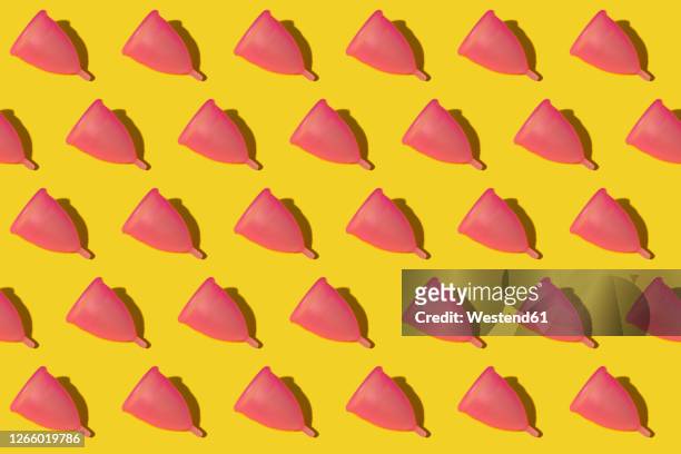 pattern of rows of pink menstrual cups - menstrual cup stock pictures, royalty-free photos & images
