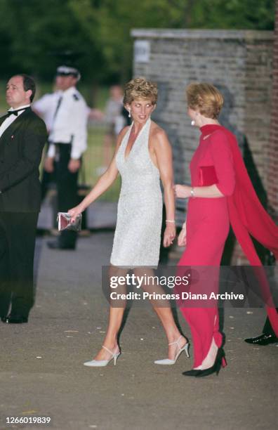 British Royal Diana, Princess of Wales , wearing a pale blue halter-neck dress by fashion designer Catherine Walker, with co-director of the...