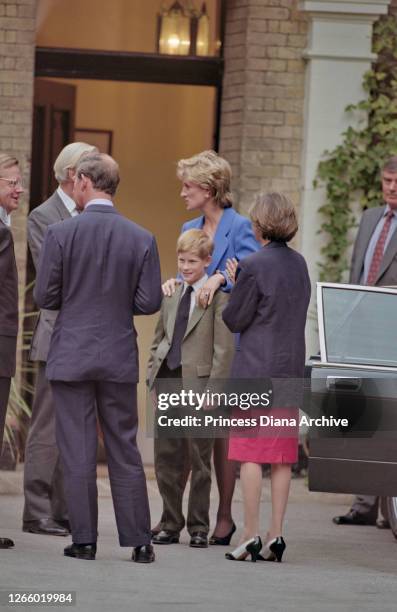 British Royal Prince Charles with his wife, Diana, Princess of Wales , wearing a blue jacket over a black dress, and Prince Harry outside Manor House...