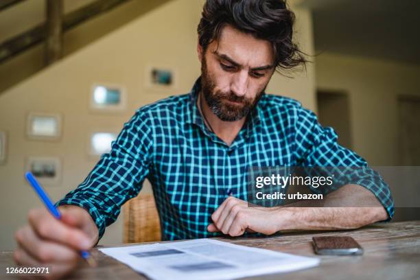 man signing papers - man signing paper stock pictures, royalty-free photos & images