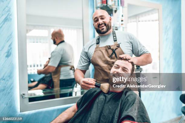 smiling barber and customer discussing beard style possibility before shaving - shaving head stock pictures, royalty-free photos & images