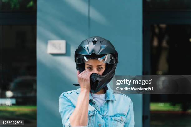 woman with black motorcycle helmet - biker jacket stock-fotos und bilder