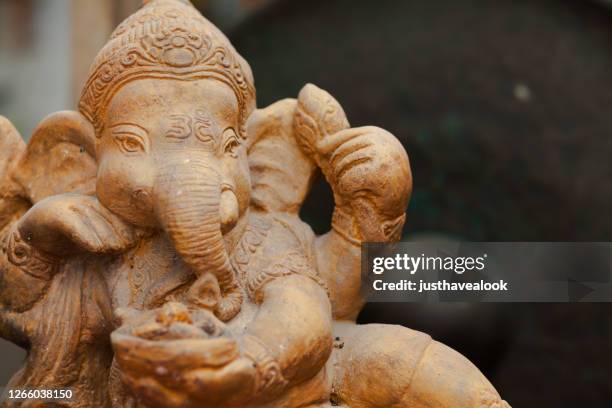 detailed shot of ganesha statue at thai shrine - brahma stock pictures, royalty-free photos & images
