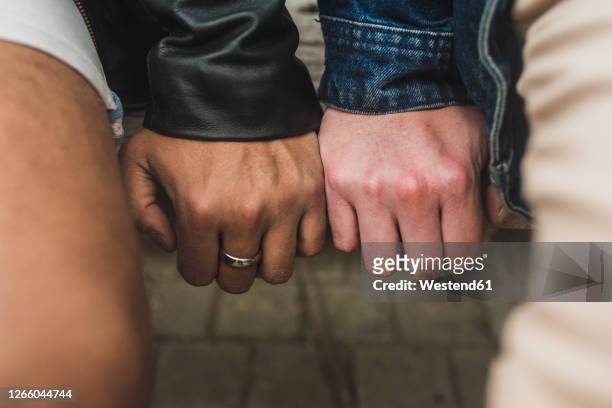 close-up of gay couple hands on table - finger touching stock pictures, royalty-free photos & images