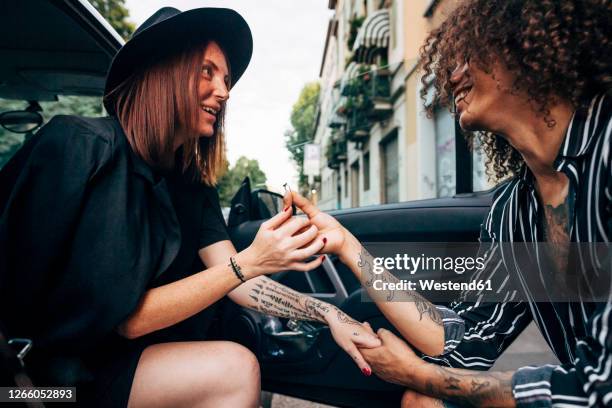 loving man with engagement ring proposing his girlfriend sitting in car - holding hands in car stock pictures, royalty-free photos & images