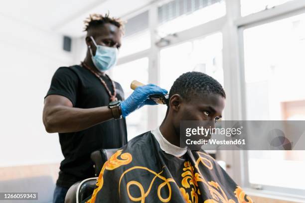 Barber Wearing Gloves And Mask Cutting Young Mans Hair With Razor In Salon  High-Res Stock Photo - Getty Images