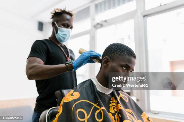 Barber Wearing Gloves And Mask Cutting Young Mans Hair With Razor In Salon High-Res Stock Photo - Getty Images Barber Wearing Gloves And Mask Cutting Young Mans Hair With Razor In Salon High-Res Stock Photo - Getty Images