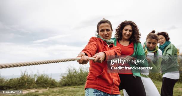 people all together in a teamwork concept - white rope stock pictures, royalty-free photos & images