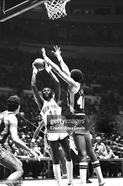 December 19: Bob McAdoo, Power Forward, of the New York Knickerbockers, shoots the basketball against James Edwards of the Indiana Pacers during an...