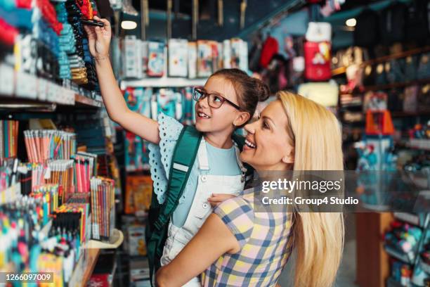 mother and daughter in a bookstore - back to school stock pictures, royalty-free photos & images