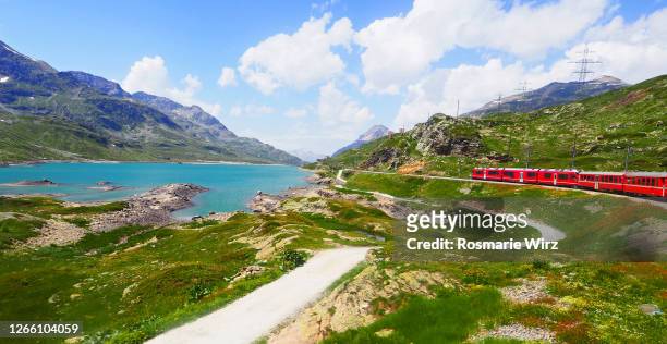bernina express train in breathtaking landscape - switzerland train stock pictures, royalty-free photos & images