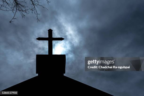 christianity religion, cross at the church of the christian faith on halloween night. - kirche stock-fotos und bilder