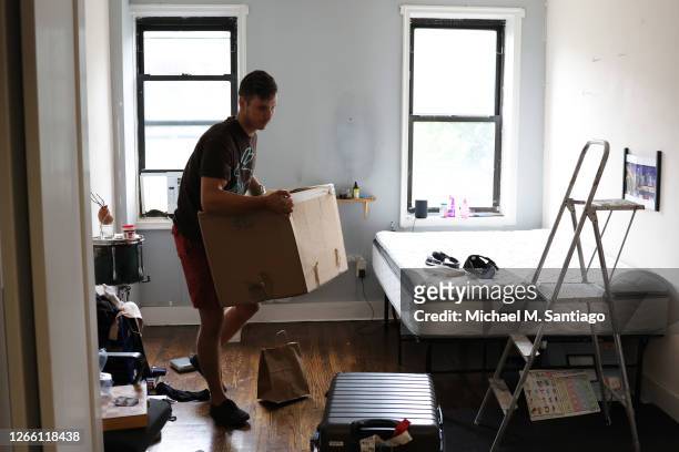Nikola Gazdic, a mover with Rabbit Movers, prepares to place the belongings of a customer on a dolly on August 13, 2020 in New York City. Moving...