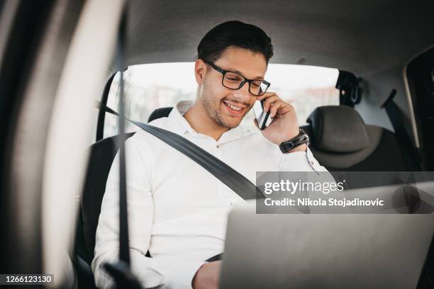 his mind is constantly on work - back seat stock pictures, royalty-free photos & images