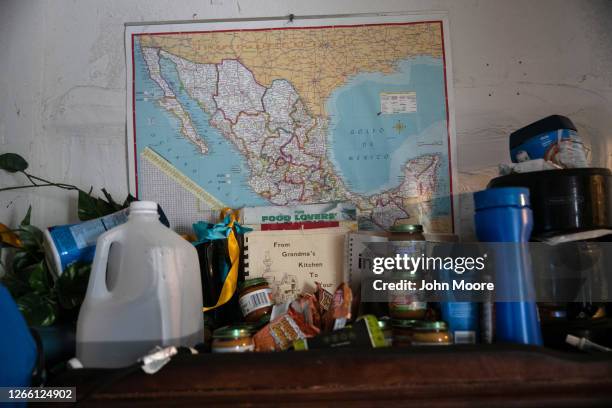 Map hangs on the wall as EMS medics with the Houston Fire Department prepare to transport an immigrant from Mexico to the hospital on August 12, 2020...