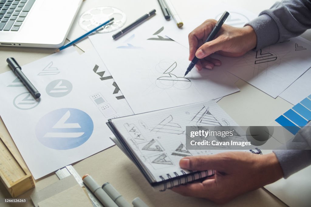 Graphic designer drawing sketch design creative Ideas draft Logo